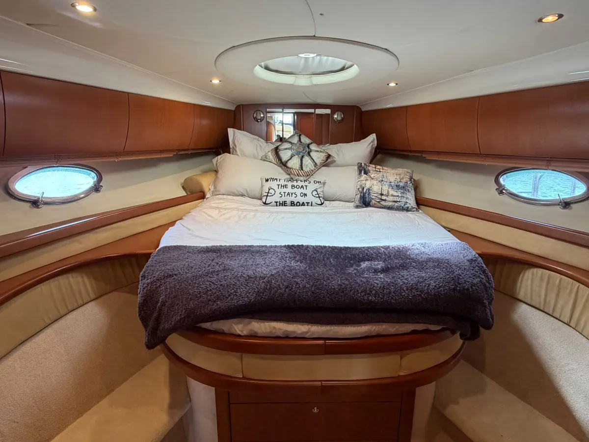 The cabin: a double bed under the hatch, with portholes either side