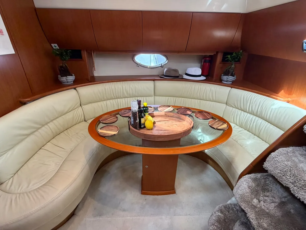 The saloon: a curved cream sofa around a round table